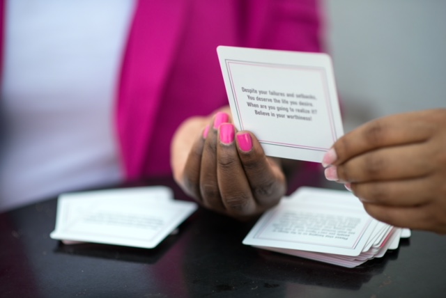 Founder holding an affirmation card